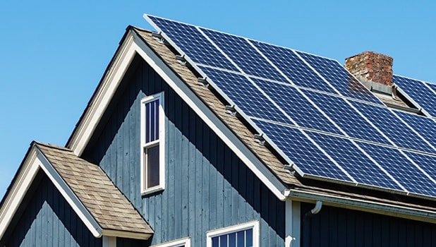 Solar panels atop a 12-pitch roof.